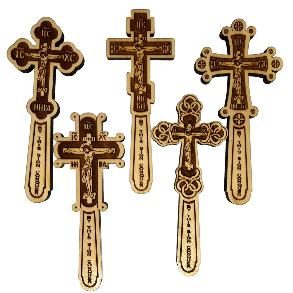 A collection of five Orthodox wooden blessing crosses with laser-cut depictions of Jesus Christ and Byzantine inscriptions.